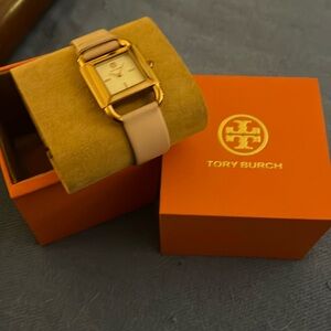 Ladies Tory Burch sport watch. Slightly used. Gold with light pink band